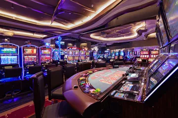 A glowing roulette wheel with cascading chips, symbolizing the engaging live and instant-win games available on CHEZA GAME.