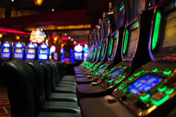A woman in a luxurious green gown next to an ornate roulette wheel, capturing the upscale casino mood of CHEZA GAME.