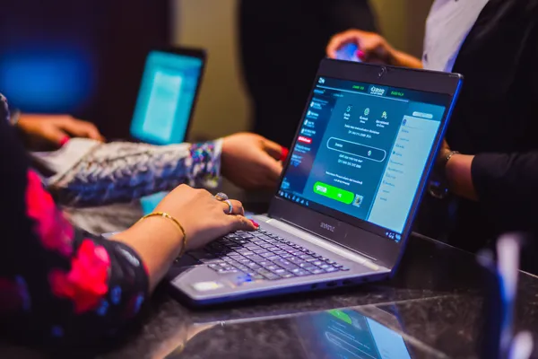 A confident dealer surrounded by casino chips inviting players to access their CHEZA GAME account, reflecting quick and easy login options.